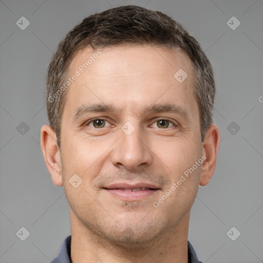 Joyful white adult male with short  brown hair and brown eyes