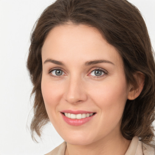 Joyful white young-adult female with medium  brown hair and grey eyes