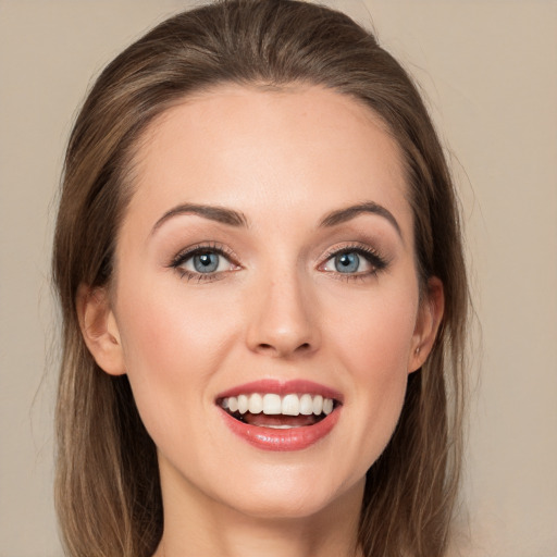 Joyful white young-adult female with long  brown hair and grey eyes