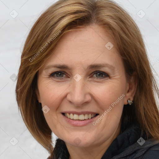 Joyful white adult female with medium  brown hair and brown eyes