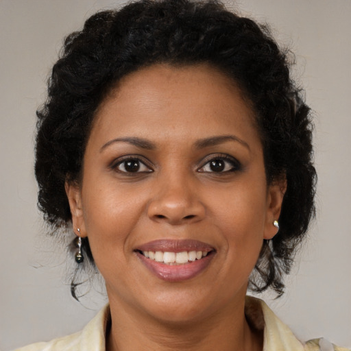 Joyful black young-adult female with medium  brown hair and brown eyes