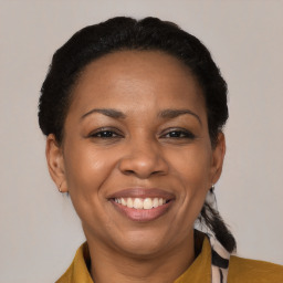 Joyful black adult female with medium  brown hair and brown eyes