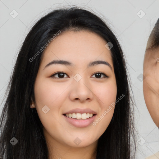 Joyful asian young-adult female with long  black hair and brown eyes