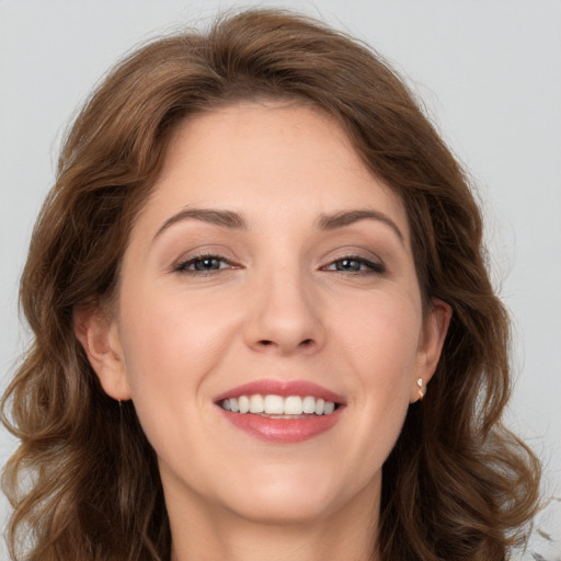 Joyful white young-adult female with long  brown hair and grey eyes