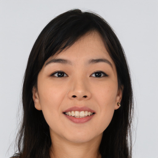 Joyful asian young-adult female with long  brown hair and brown eyes