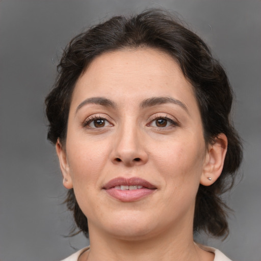 Joyful white adult female with medium  brown hair and brown eyes