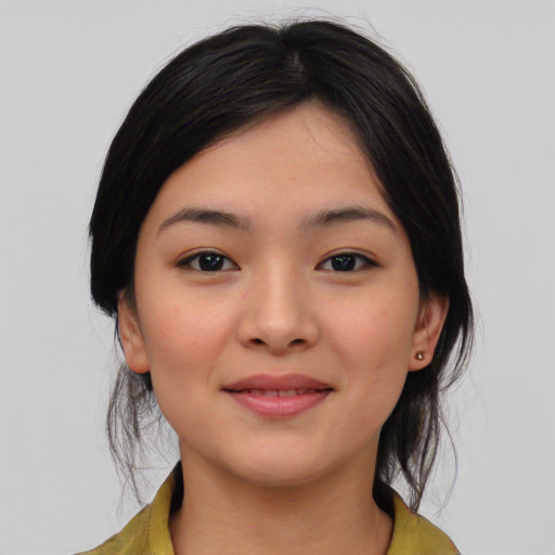 Joyful asian young-adult female with medium  black hair and brown eyes