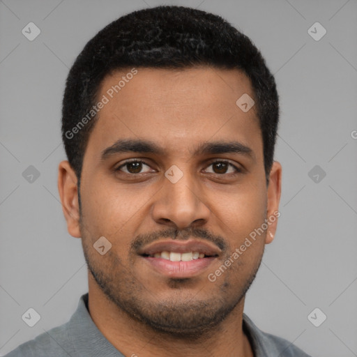 Joyful latino young-adult male with short  black hair and brown eyes