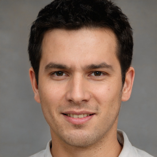 Joyful white young-adult male with short  brown hair and brown eyes