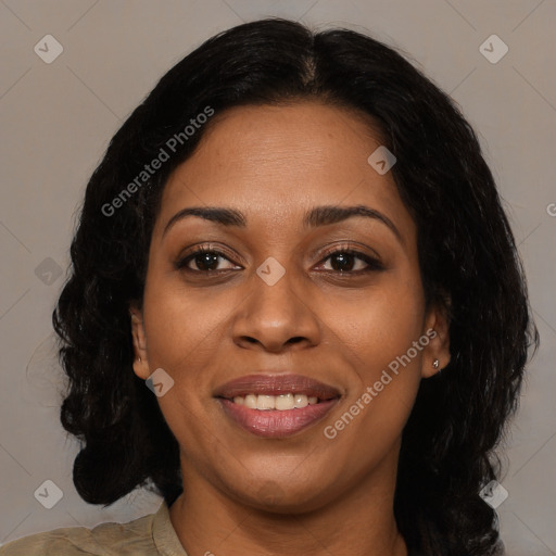 Joyful black adult female with medium  brown hair and brown eyes