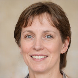 Joyful white adult female with medium  brown hair and grey eyes