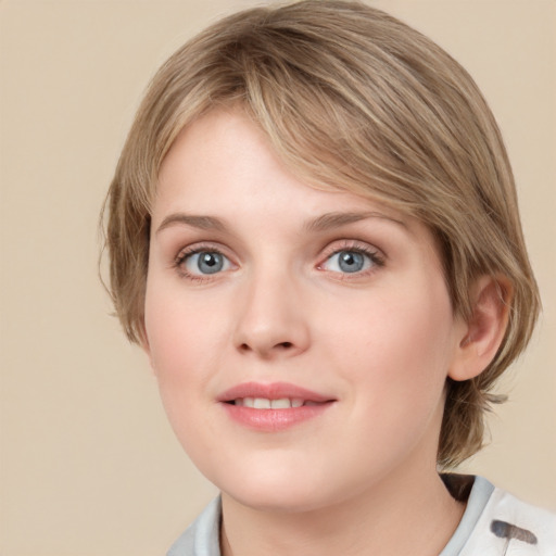 Joyful white young-adult female with medium  brown hair and blue eyes