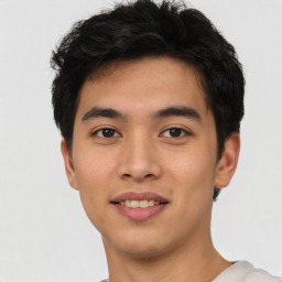 Joyful asian young-adult male with short  black hair and brown eyes