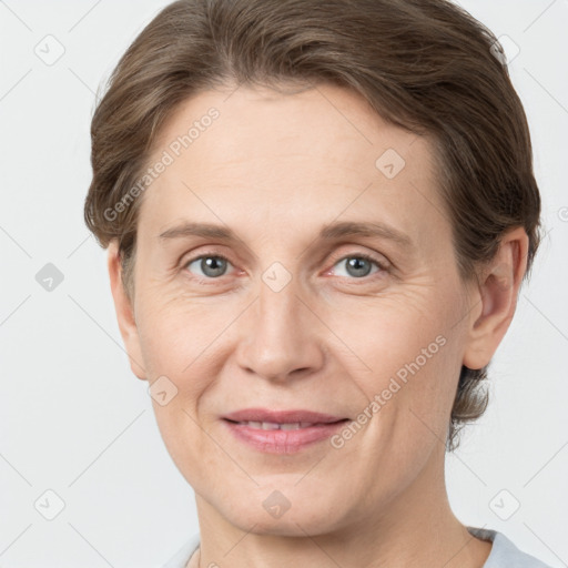 Joyful white adult female with short  brown hair and grey eyes