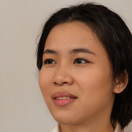 Joyful asian young-adult female with medium  brown hair and brown eyes