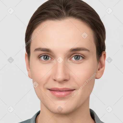 Joyful white young-adult female with short  brown hair and grey eyes