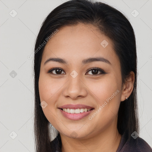 Joyful asian young-adult female with long  brown hair and brown eyes