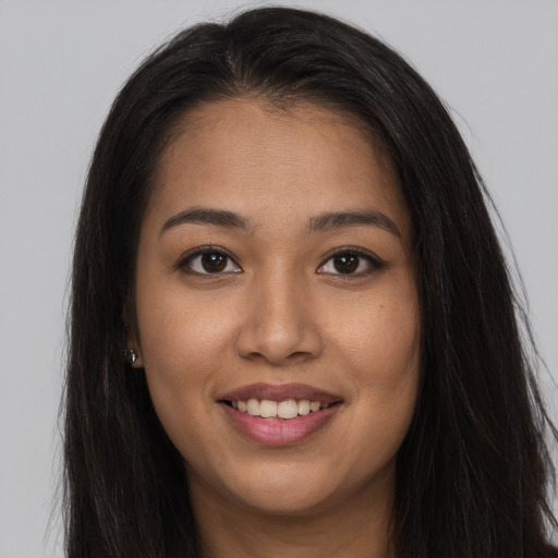 Joyful asian young-adult female with long  brown hair and brown eyes