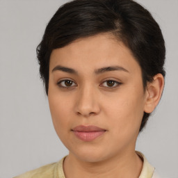 Joyful latino young-adult female with medium  brown hair and brown eyes