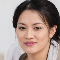 Joyful asian young-adult female with medium  brown hair and brown eyes