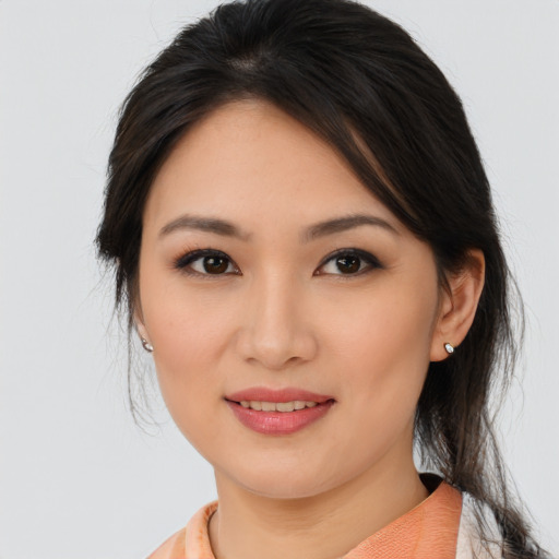 Joyful asian young-adult female with medium  brown hair and brown eyes