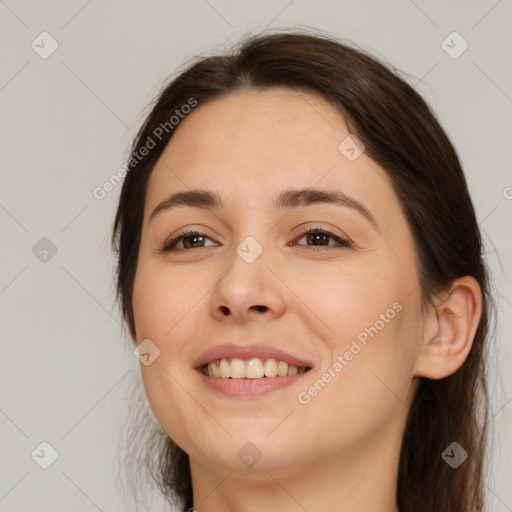 Joyful white young-adult female with long  brown hair and brown eyes