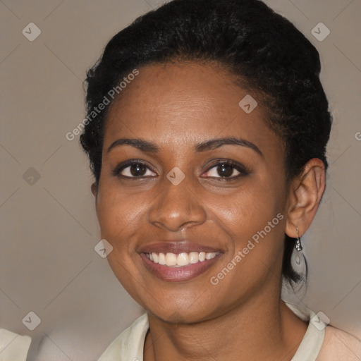 Joyful black young-adult female with short  brown hair and brown eyes