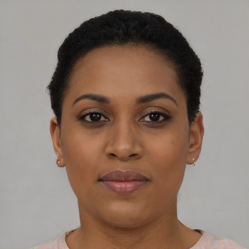 Joyful black young-adult female with short  brown hair and brown eyes