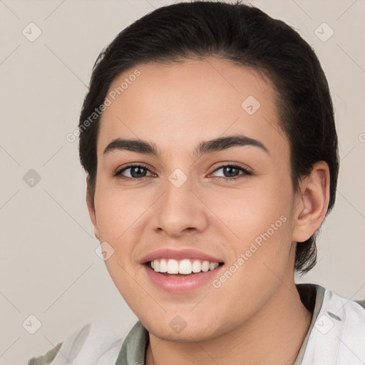 Joyful white young-adult female with short  brown hair and brown eyes