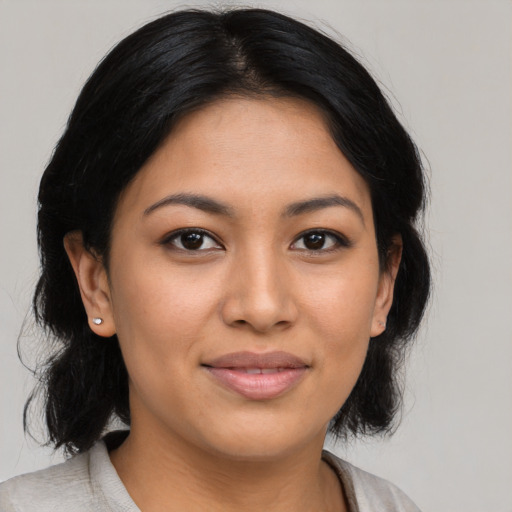 Joyful latino young-adult female with medium  black hair and brown eyes
