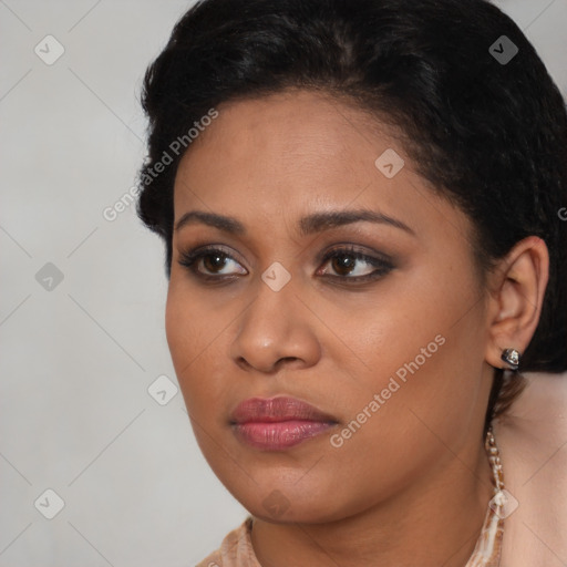 Joyful black young-adult female with long  brown hair and brown eyes