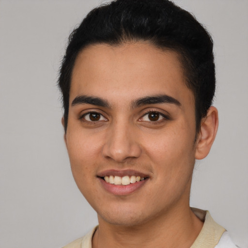 Joyful latino young-adult male with short  brown hair and brown eyes