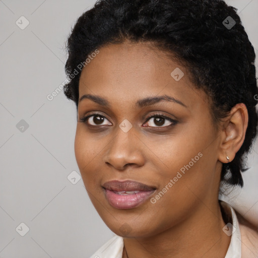 Joyful black young-adult female with short  black hair and brown eyes