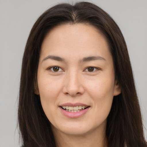 Joyful white young-adult female with long  brown hair and brown eyes