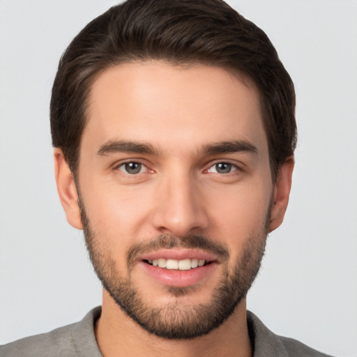 Joyful white young-adult male with short  brown hair and brown eyes