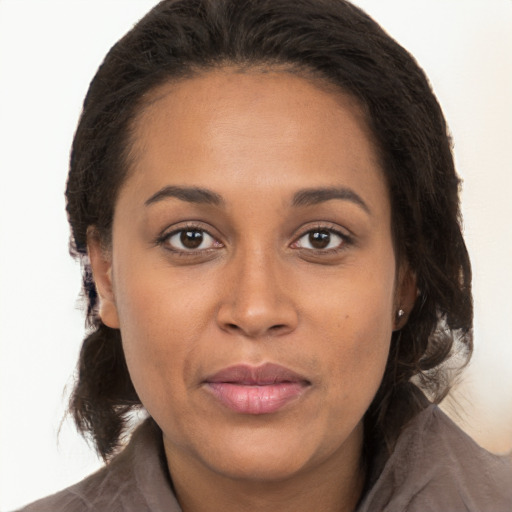 Joyful latino young-adult female with long  brown hair and brown eyes