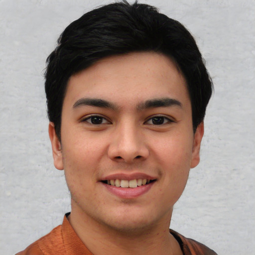 Joyful asian young-adult male with short  black hair and brown eyes