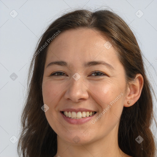 Joyful white adult female with long  brown hair and brown eyes