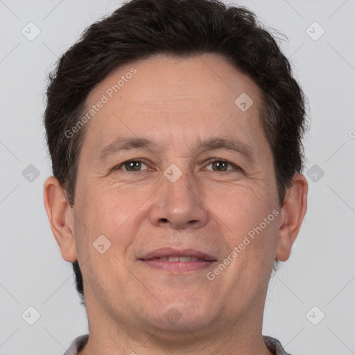 Joyful white adult male with short  brown hair and brown eyes