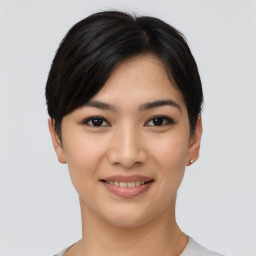 Joyful asian young-adult female with short  black hair and brown eyes