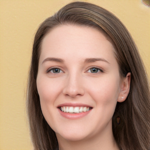 Joyful white young-adult female with long  brown hair and grey eyes