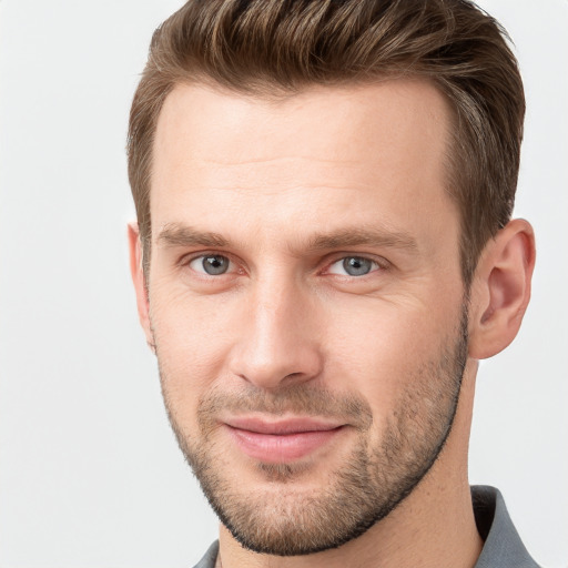 Joyful white young-adult male with short  brown hair and grey eyes