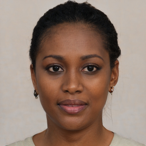 Joyful black young-adult female with short  black hair and brown eyes