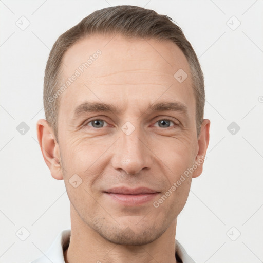 Joyful white adult male with short  brown hair and grey eyes