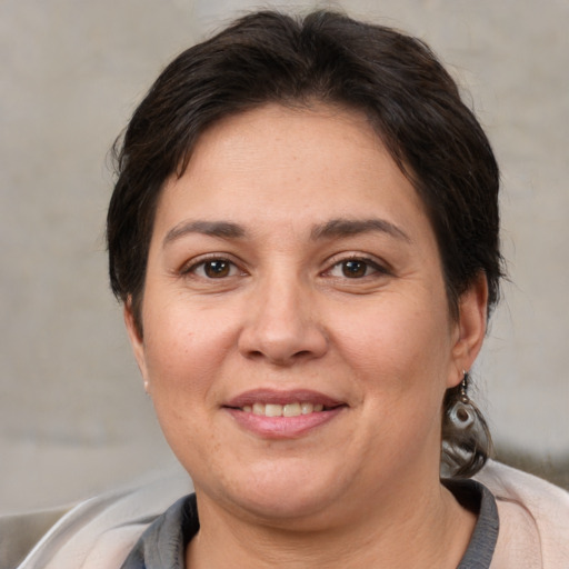 Joyful white adult female with short  brown hair and brown eyes