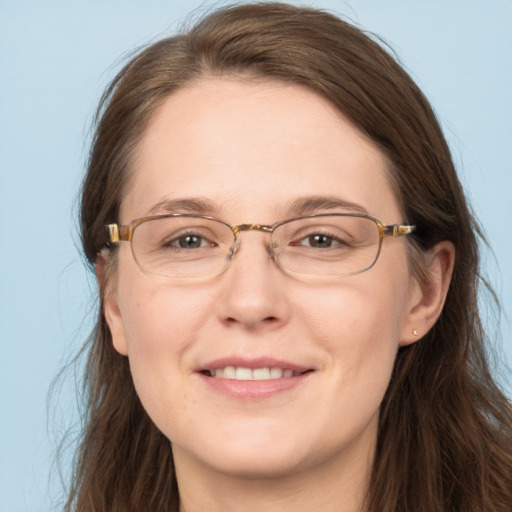 Joyful white adult female with long  brown hair and brown eyes