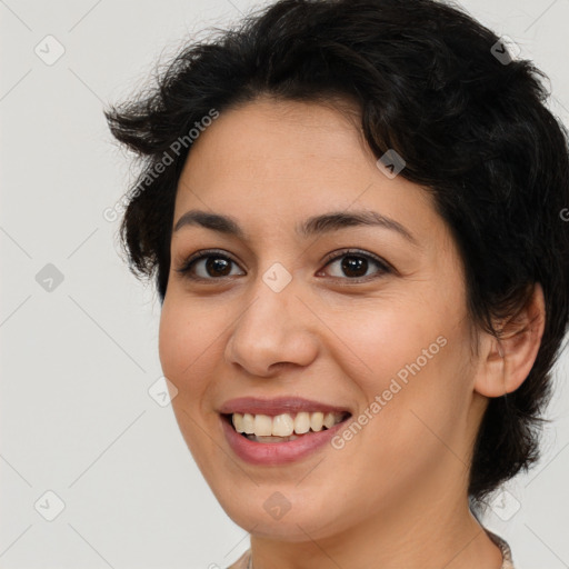 Joyful latino young-adult female with medium  brown hair and brown eyes