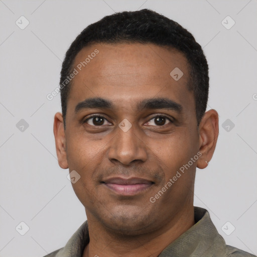 Joyful black young-adult male with short  black hair and brown eyes