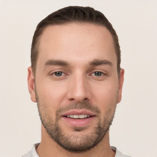 Joyful white young-adult male with short  brown hair and brown eyes