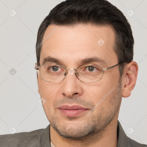 Joyful white adult male with short  brown hair and brown eyes